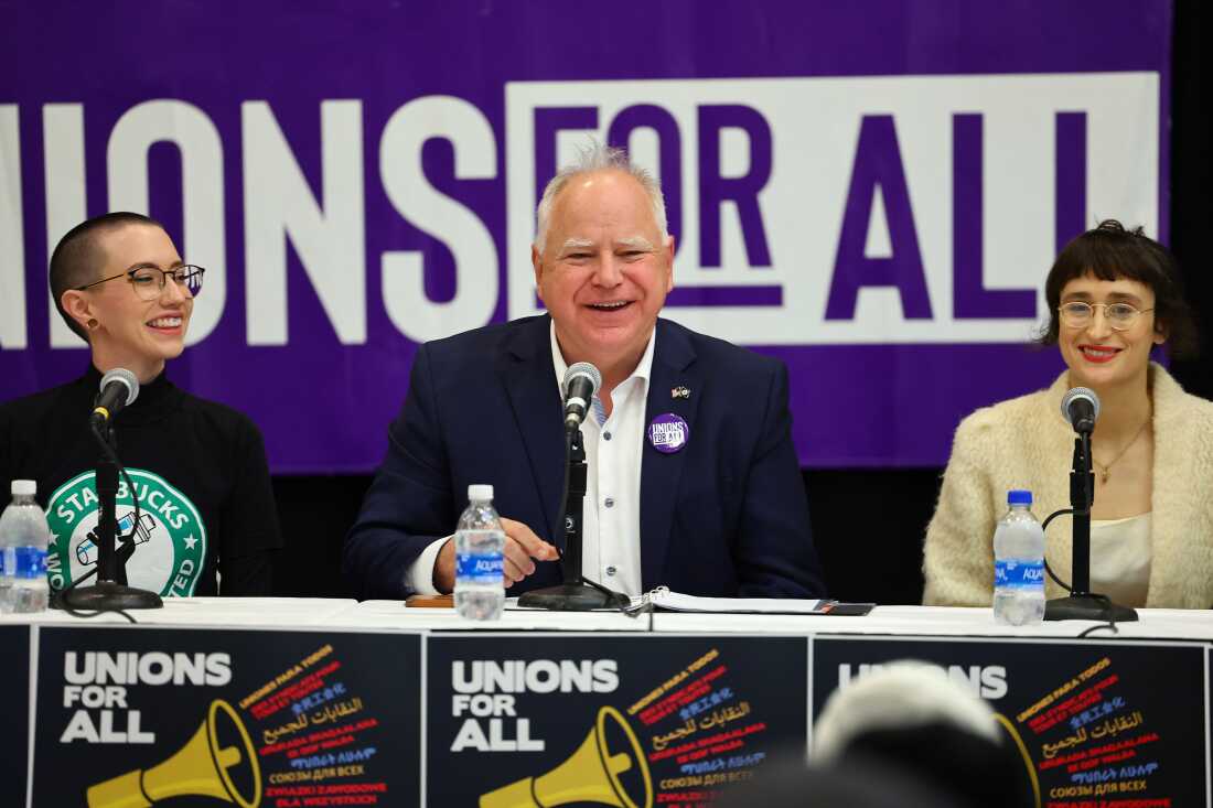 Minnesota Gov. Tim Walz speaks with union organizers before they march on businesses in downtown Minneapolis on Oct. 14, 2022.