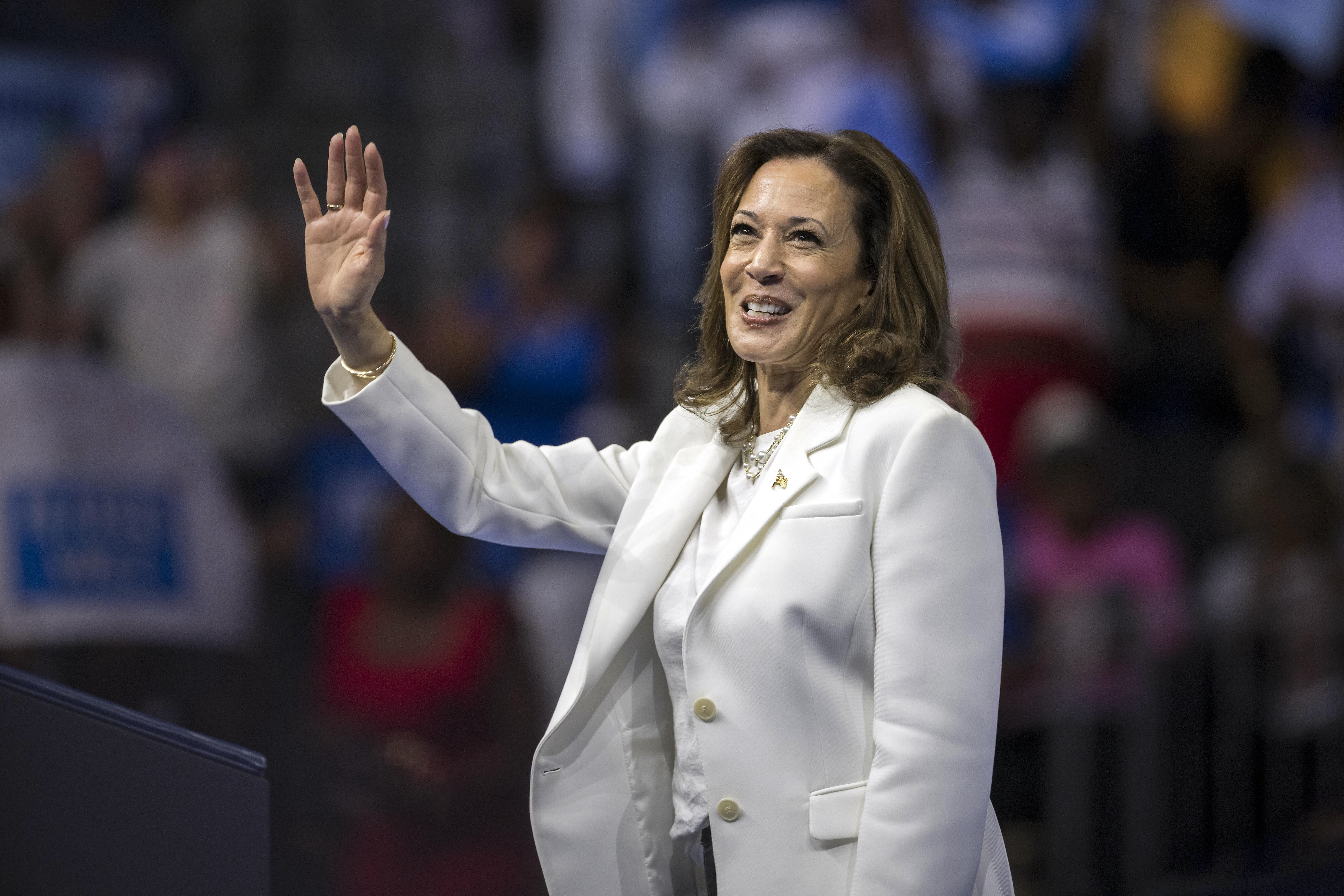 Democratic presidential nominee Vice President Kamala Harris waves at a campaign rally.