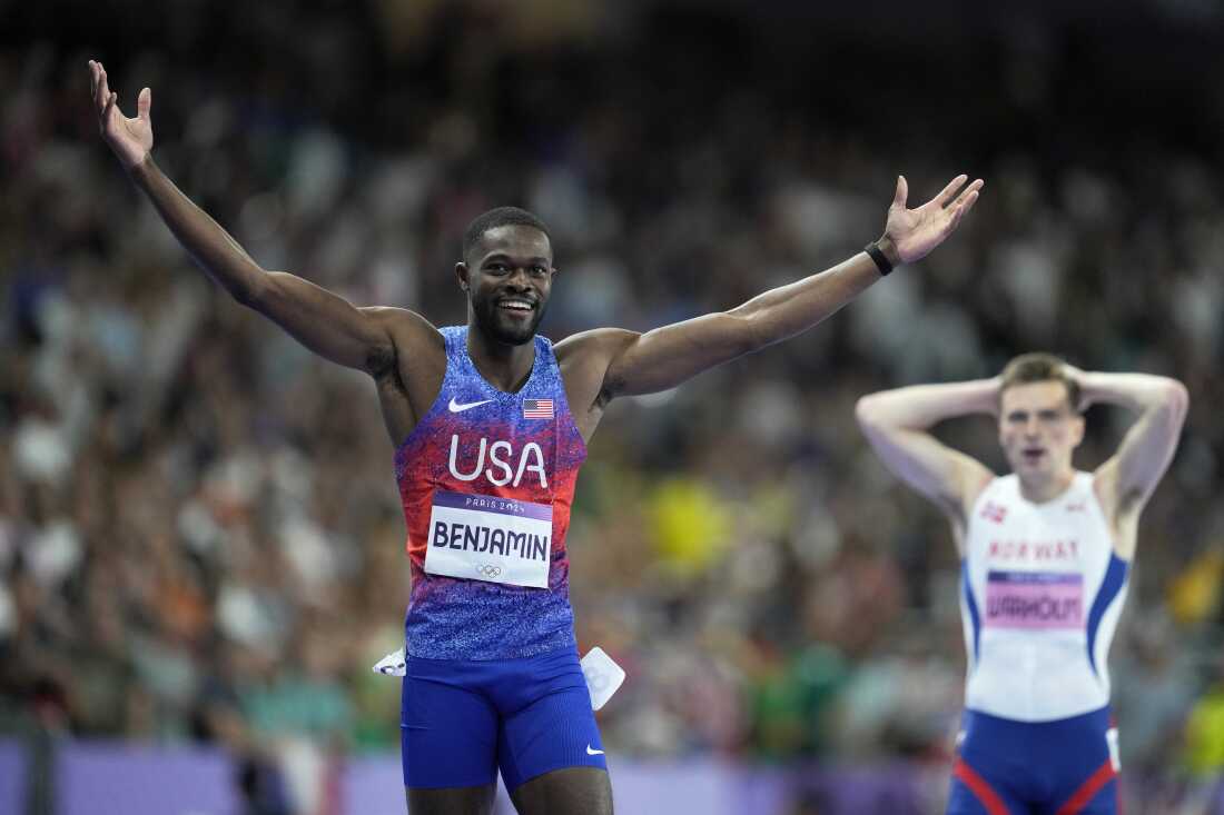 Rai Benjamin of the U.S. celebrates after winning gold ahead of silver medalist Karsten Warholm of Norway, seen behind him, in the 400-meter hurdles final at the Paris Olympics on Friday.