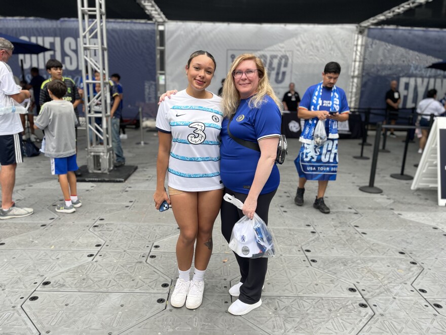 Briana Elmore, 20, mingles in the fan zone with her mother before heading into the stadium.