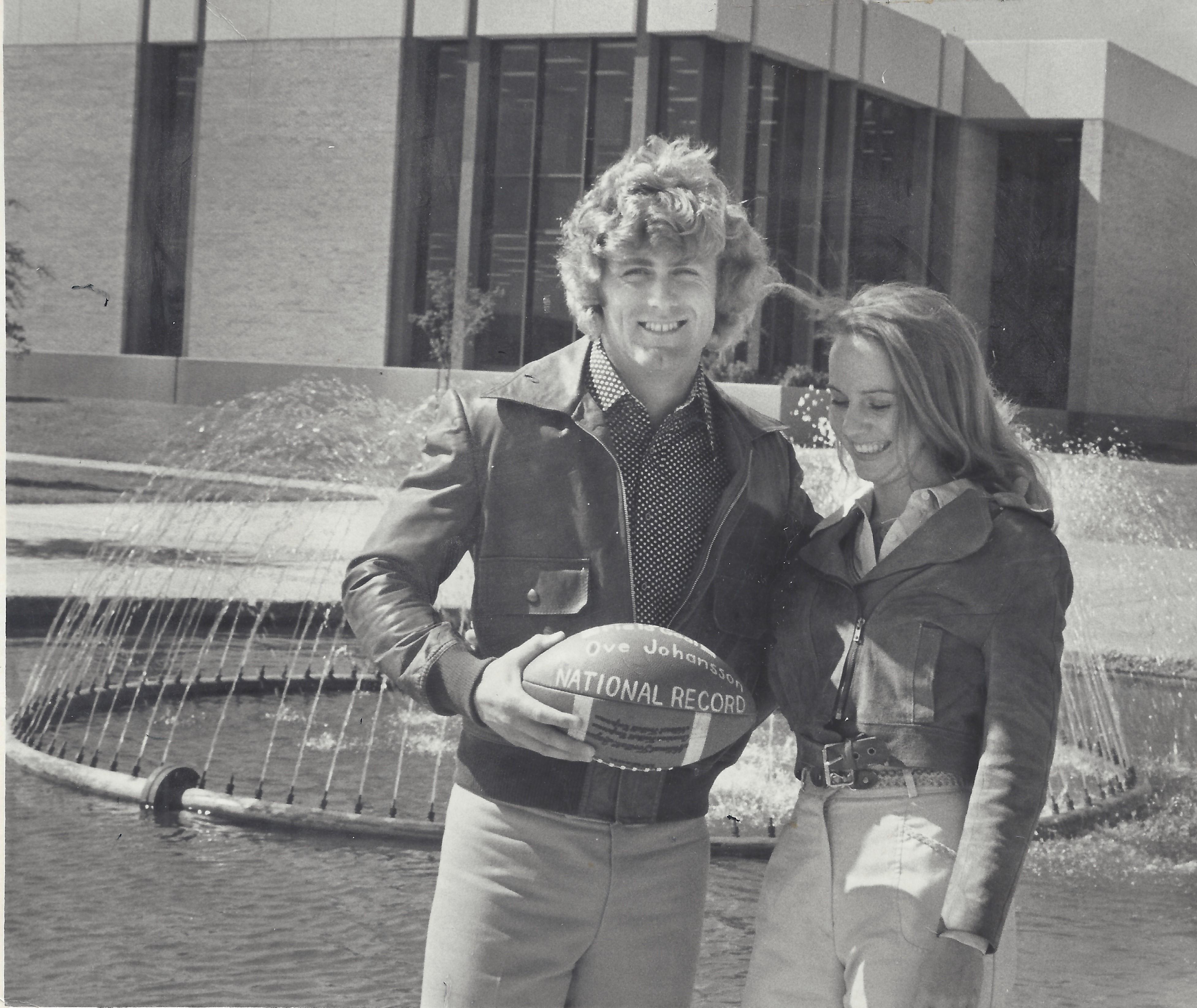 Ove and April Johansson posing with the football used in the record-breaking field goal kick.