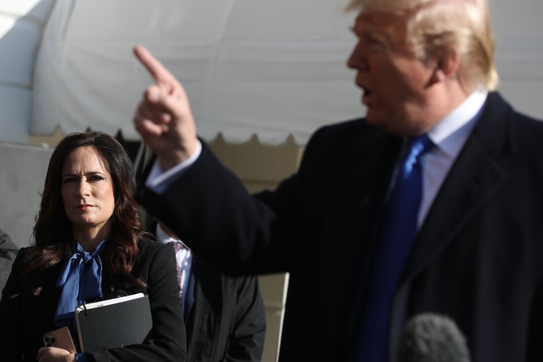 White House Press Secretary Stephanie Grisham (L) listens to U.S. President Donald Trump talk to reporters, November 08, 2019 in Washington, DC.