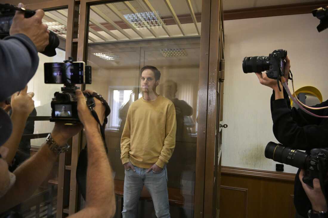 Wall Street Journal reporter Evan Gershkovich stands in the glass defendant's booth at the Moscow City Court, in Moscow on Sept. 19, 2023.