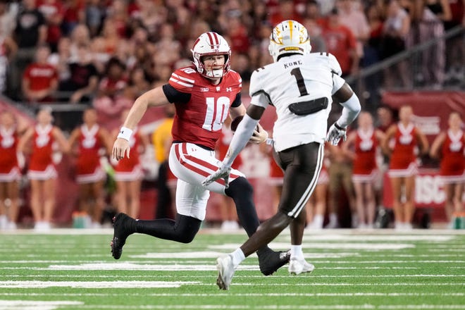 Wisconsin Badgers quarterback Tyler Van Dyke (10) rushes with the football as Western Michigan Broncos cornerback Bilhal Kone (1) defends during the first quarter at Camp Randall Stadium on Aug. 30, 2024.