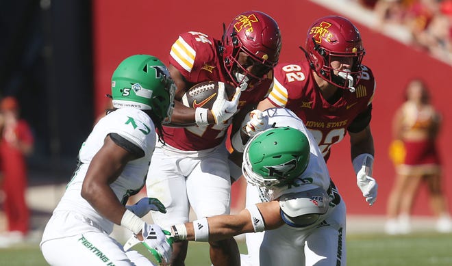 Iowa State Cyclones running back Abu Sama III (24) battles for a few yards as getting a tackle North Dakota Fighting Hawks defensive back Clayton Bishop (5) and linebacker Dylan Boecker (32) during the third quarter in the season opening game at Jack Trice Stadium on Aug. 31, 2024,  in Ames, Iowa