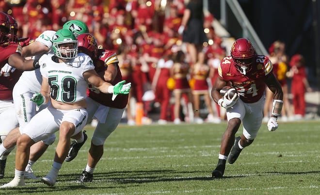 Iowa State Cyclones running back Abu Sama III (24) runs with the ball around North Dakota Fighting Hawks linebacker Wyatt Pedigo (59) during the third quarter in the season opening game at Jack Trice Stadium on Aug. 31, 2024,  in Ames, Iowa