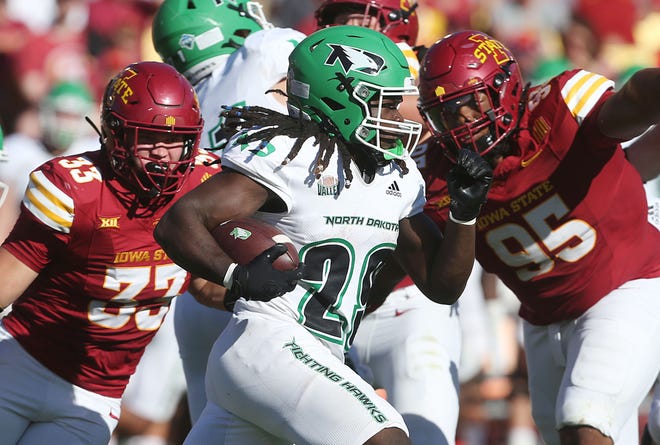 Iowa State Cyclones defensive line Domonique Orange (95) and inebacker Jack Sadowsky (33) attempt to tackle as North Dakota Fighting Hawks running back Isaiah Smith (29) runs for first down during the fourth quarter in the season opening game at Jack Trice Stadium on Aug. 31, 2024,  in Ames, Iowa