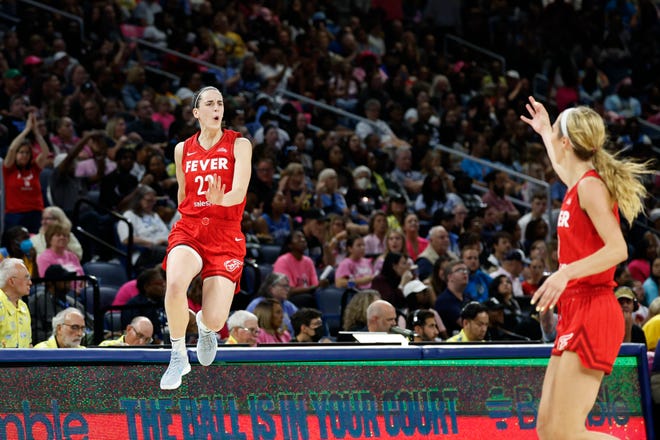 Indiana Fever guard Caitlin Clark (22) celebrates after scoring against the Chicago Sky during the second half at Wintrust Arena.