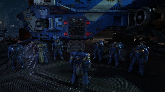 Space marines gather in front of a drop ship.