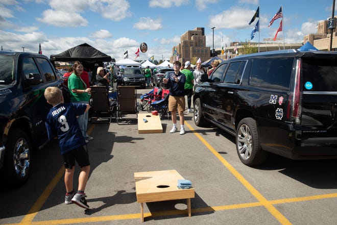 Evan Milley, left, throws a football to his step brother Max Szuba at a tailgate before a NCAA college football game between Notre Dame and Northern Illinois at Notre Dame Stadium on Saturday, Sept. 7, 2024, in South Bend.