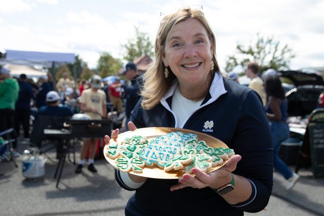 Notre Dame graduate Rose Rozembajgjer poses for a photo with the Notre Dame themed cookies she made for a tailgate before a NCAA college football game between Notre Dame and Northern Illinois at Notre Dame Stadium on Saturday, Sept. 7, 2024, in South Bend.