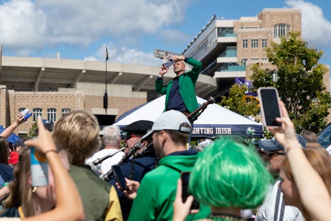 Vincent Rockne takes a photo of Bernie VanEtten's tailgate before a NCAA college football game between Notre Dame and Northern Illinois at Notre Dame Stadium on Saturday, Sept. 7, 2024, in South Bend. VanEtten owns a stone company that donated the head stones for the new gravesites of the Rockne family on Notre Dame's campus.