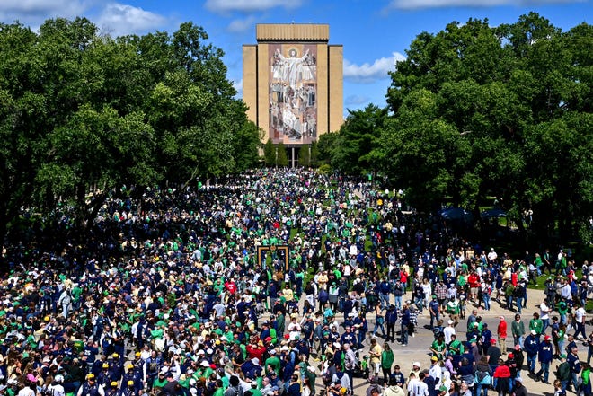 Sep 7, 2024; South Bend, Indiana, USA; Fans gather in front of the Word of Life mural, commonly known as Touchdown Jesus, before the game between the Notre Dame Fighting Irish and the Northern Illinois Huskies at Notre Dame Stadium. Mandatory Credit: Matt Cashore-Imagn Images