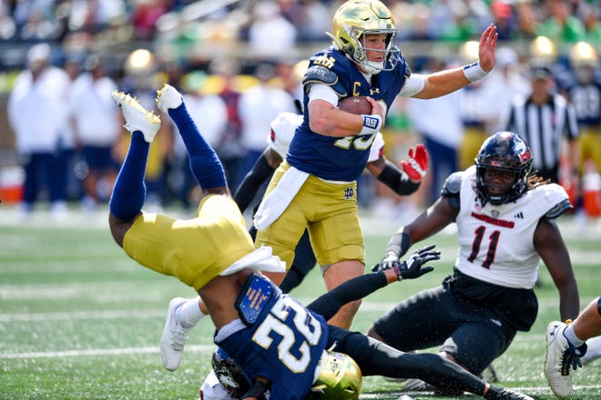 Sep 7, 2024; South Bend, Indiana, USA; Notre Dame Fighting Irish quarterback Riley Leonard (13) runs for a touchdown in the first quarter against the Northern Illinois Huskies at Notre Dame Stadium. Mandatory Credit: Matt Cashore-Imagn Images