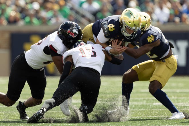 Notre Dame quarterback Riley Leonard (13) is tackled in the air during a NCAA college football game between Notre Dame and Northern Illinois at Notre Dame Stadium on Saturday, Sept. 7, 2024, in South Bend.