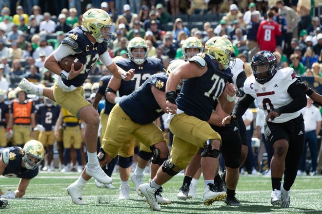 Notre Dame quarterback Riley Leonard (13) leaps through the air on his way to score a touchdown during a NCAA college football game between Notre Dame and Northern Illinois at Notre Dame Stadium on Saturday, Sept. 7, 2024, in South Bend.