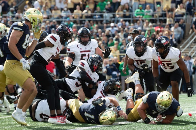 Notre Dame quarterback Riley Leonard (13) falls backwards into the end zone to score a touchdown during a NCAA college football game between Notre Dame and Northern Illinois at Notre Dame Stadium on Saturday, Sept. 7, 2024, in South Bend.