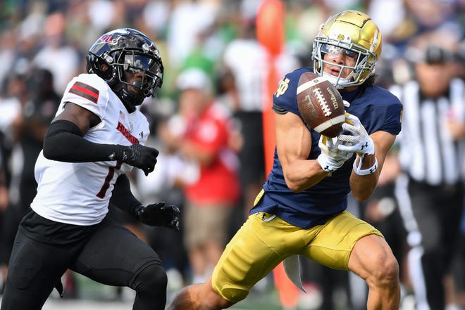 Sep 7, 2024; South Bend, Indiana, USA; Notre Dame Fighting Irish wide receiver Jaden Greathouse (1) attempts to catch a pass as Northern Illinois Huskies defensive back Jashon Prophete (1) defends in the second quarter at Notre Dame Stadium. Mandatory Credit: Matt Cashore-Imagn Images