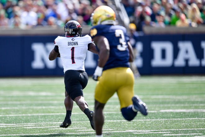 Sep 7, 2024; South Bend, Indiana, USA; Northern Illinois Huskies running back Antario Brown (1) catches a pass for a touchdown as Notre Dame Fighting Irish linebacker Jaylen Sneed (3) pursues in the first quarter at Notre Dame Stadium. Mandatory Credit: Matt Cashore-Imagn Images