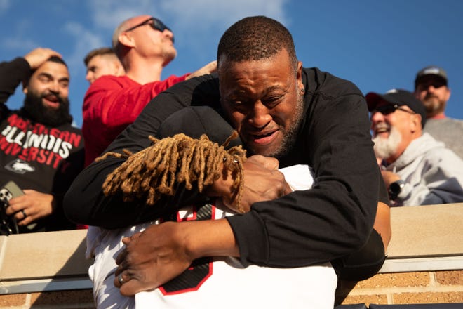 Northern Illinois defensive tackle Devonte O'Malley hugs his crying father Trumane Hampton after wining a NCAA college football game 16-14 against Notre Dame at Notre Dame Stadium on Saturday, Sept. 7, 2024, in South Bend.