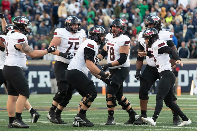 Northern Illinois place kicker Kanon Woodill (92) is celebrated by teammates after making a late fourth quarter field goal that would lead his team to win a NCAA college football game against Notre Dame at Notre Dame Stadium on Saturday, Sept. 7, 2024, in South Bend.