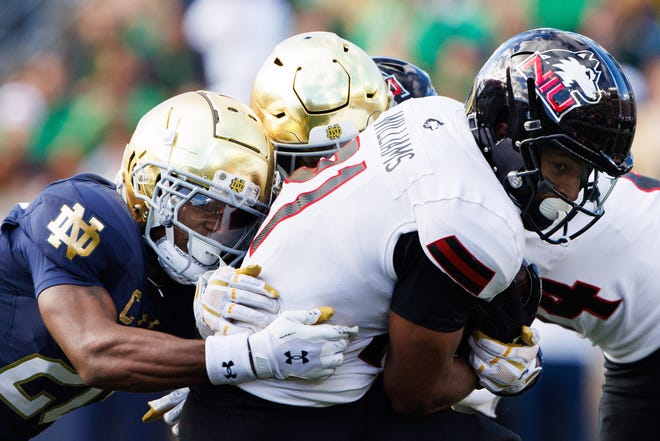 Northern Illinois running back Gavin Williams (21) attempts to break free from Notre Dame's defense during a NCAA college football game between Notre Dame and Northern Illinois at Notre Dame Stadium on Saturday, Sept. 7, 2024, in South Bend.