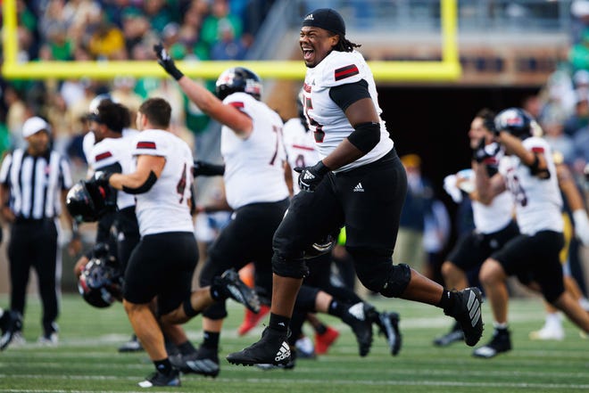 Northern Illinois offensive lineman Abiathar Curry jumps in the air in celebration after wining a NCAA college football game 16-14 against Notre Dame at Notre Dame Stadium on Saturday, Sept. 7, 2024, in South Bend.