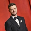 Justin Timberlake, wearing a tux, poses for a photo at the Vanity Fair Oscar Party.