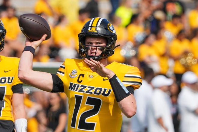 Sep 14, 2024; Columbia, Missouri, USA; Missouri Tigers quarterback Brady Cook (12) warms up against the Boston College Eagles prior to a game at Faurot Field at Memorial Stadium. Mandatory Credit: Denny Medley-Imagn Images