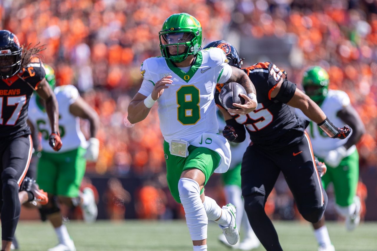 Oregon quarterback Dillon Gabriel (#8) sprints down the sideline