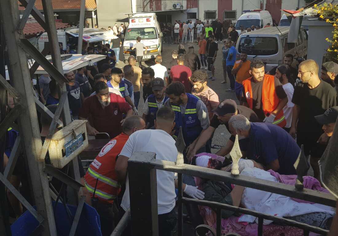 Health workers carry a man who was wounded after when a pager exploded in Lebanon's southern port city of Sidon.