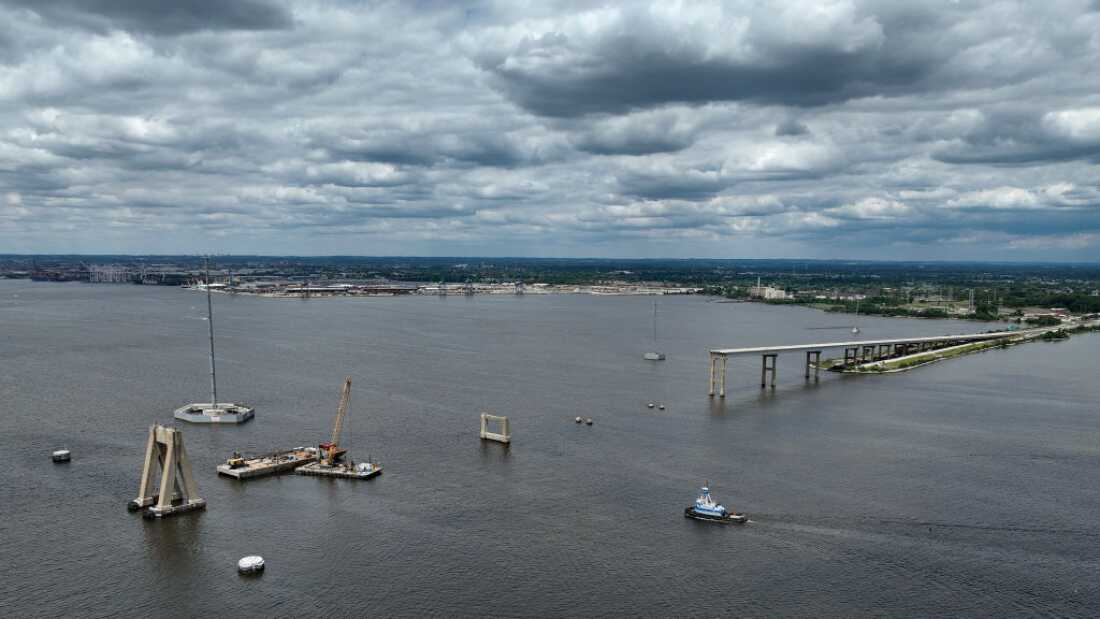 In an aerial view, a tug boat travels towards the Port of Baltimore as salvage crews continue to clean up wreckage from the collapse of the Francis Scott Key Bridge in the Patapsco River on June 11 in Baltimore. 