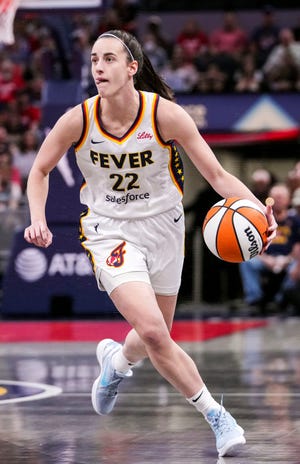 Indiana Fever guard Caitlin Clark (22) dribbles the ball up the court during Friday's 99-88 loss to the Minnesota Lynx at Gainbride Fieldhouse in Indianapolis.