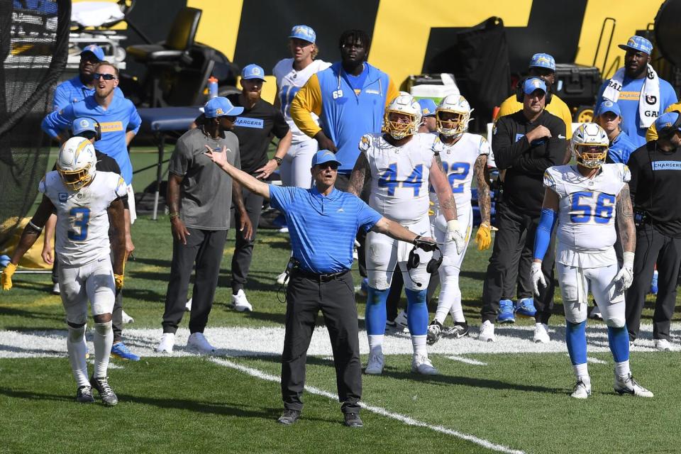 Chargers coach Jim Harbaugh, center, reacts during the second half of Sunday's game.