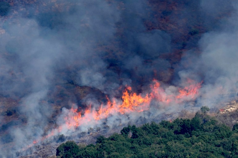 Flames and smoke rise from an Israeli airstrike on the Mahmoudieh mountain