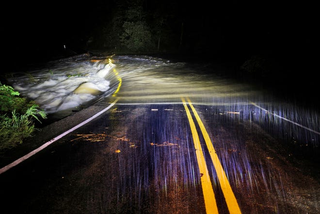 Flood waters wash over Guy Ford Road bridge on the Watauga River as Hurricane Helene approaches in the North Carolina mountains, in Sugar Grove, North Carolina, U.S. September 26, 2024.