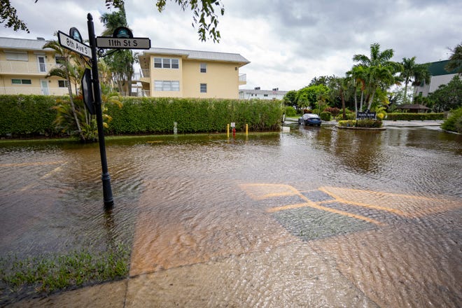 Water from Naples Bay floods the area at Eighth Avenue South and 11th Street South in Naples as Hurricane Helene passes off the coast on Sept. 26, 2024.