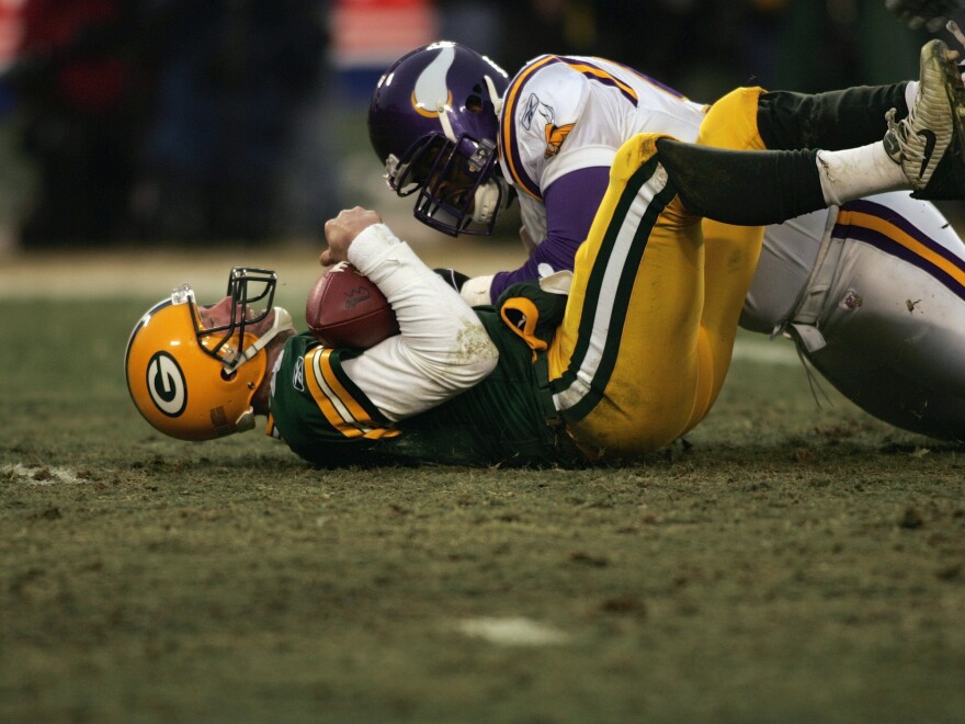 Brett Favre #4 of the Green Bay Packers is tackled by a Minnesota Vikings defensive player during the NFC wild-card game at Lambeau Field on January 9, 2005 in Green Bay, Wisconsin. Favre said Tuesday he's battling Parkinson's disease which comes after a 20-year all-star NFL career where he had numerous concussions.