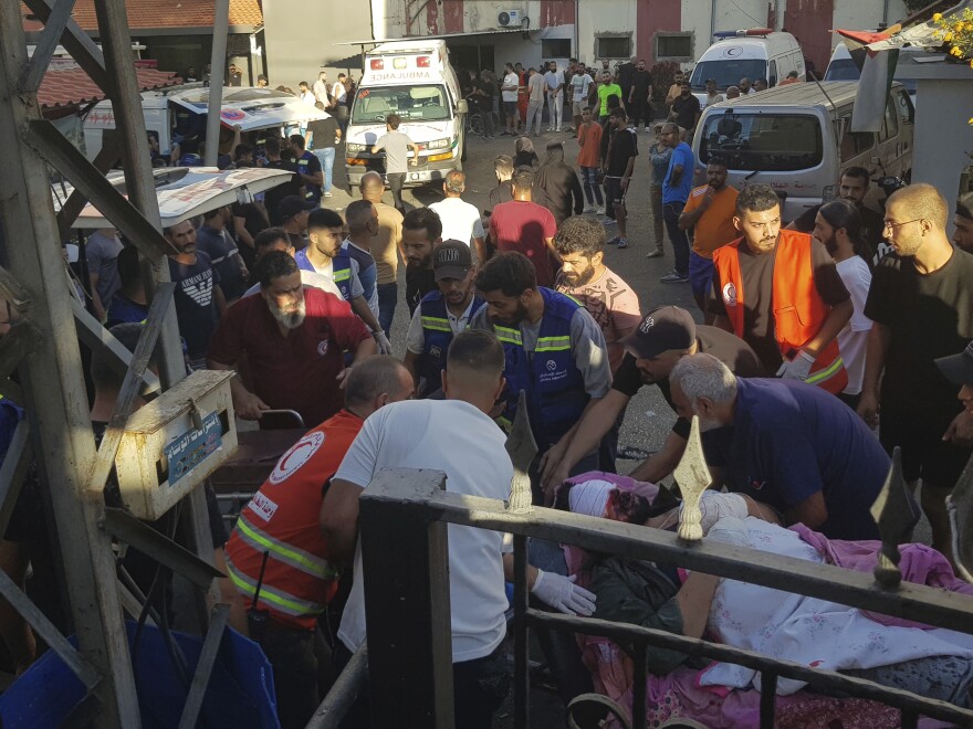 Health workers carry a man who was wounded after when a pager exploded in Lebanon's southern port city of Sidon. 