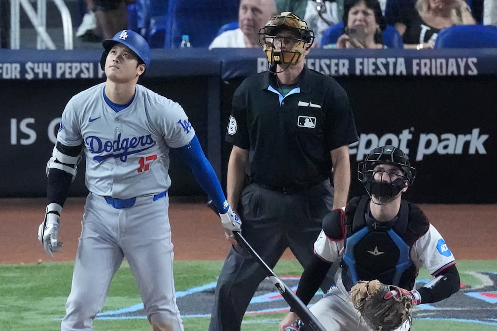 Los Angeles Dodgers' Shohei Ohtani, left, of Japan, watches the ball as he hits a home run,...