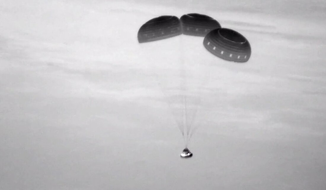 This image, taken from NASA video, shows the Boeing Starliner capsule coming down through the darkness over New Mexico.