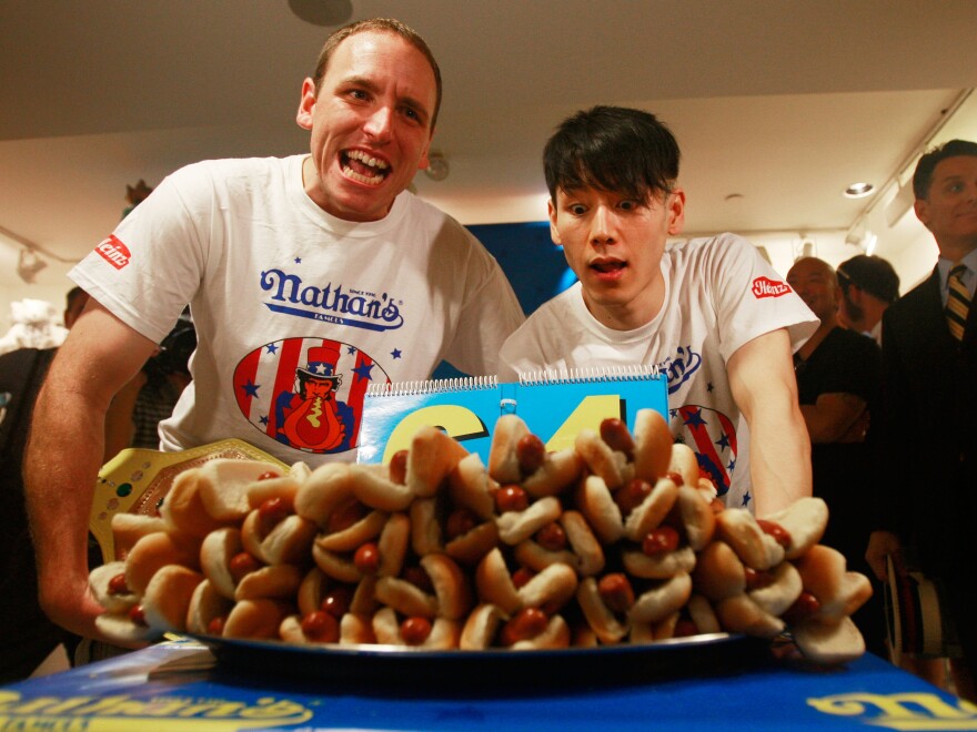 Takeru Kobayashi and champion Joey Chestnut look on at the Nathan's Famous Fourth of July International Hot Dog Eating Contest official weigh-in ceremony in July 2009. That was the last year they competed against each other, until Monday. 