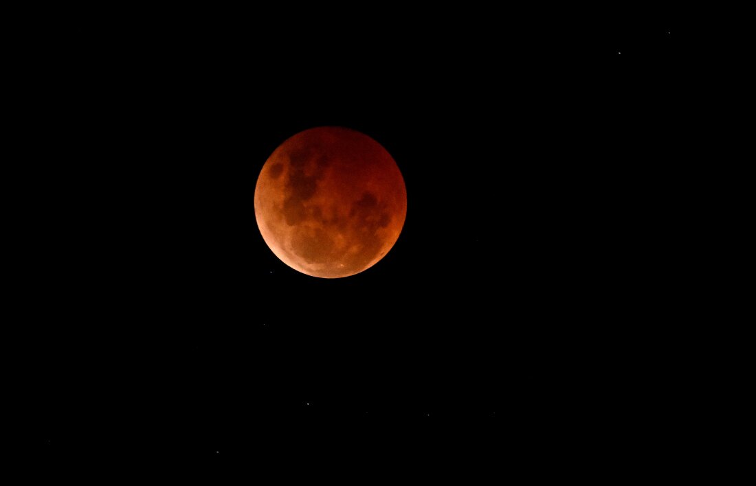 A blood moon is seen during a lunar eclipse on Nov. 8, 2022, over Brisbane, Australia.