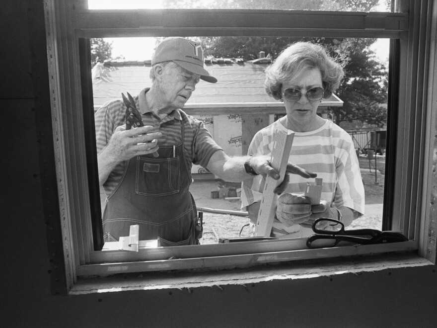 Jimmy Carter and Rosalynn Carter work at a Habitat for Humanity site in Atlanta in 1988, building houses for needy people. They volunteered one week a year with the organization for more than 35 years.