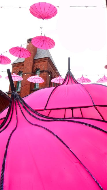 The Pink Power Parasol Project is now hanging in the Cherry Lane Alley behind Central Market in York. About 100 parasols were hung Thursday, September 26, 2024, and will remain there throughout October to bring awareness to Breast Cancer Awareness Month. The North George Street bridge over the Codorus Creek is also decorated. Bil Bowden photo