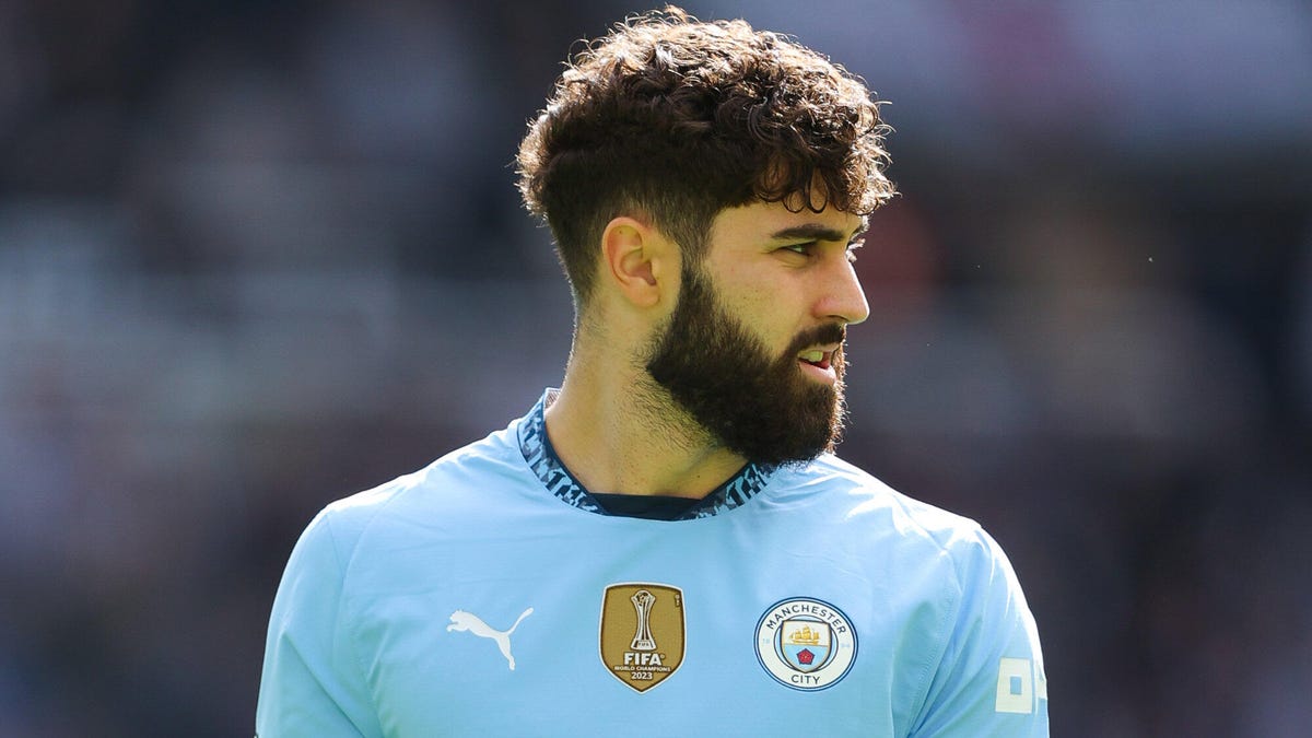 Josko Gvardiol of Manchester City looking over his shoulder to his left.