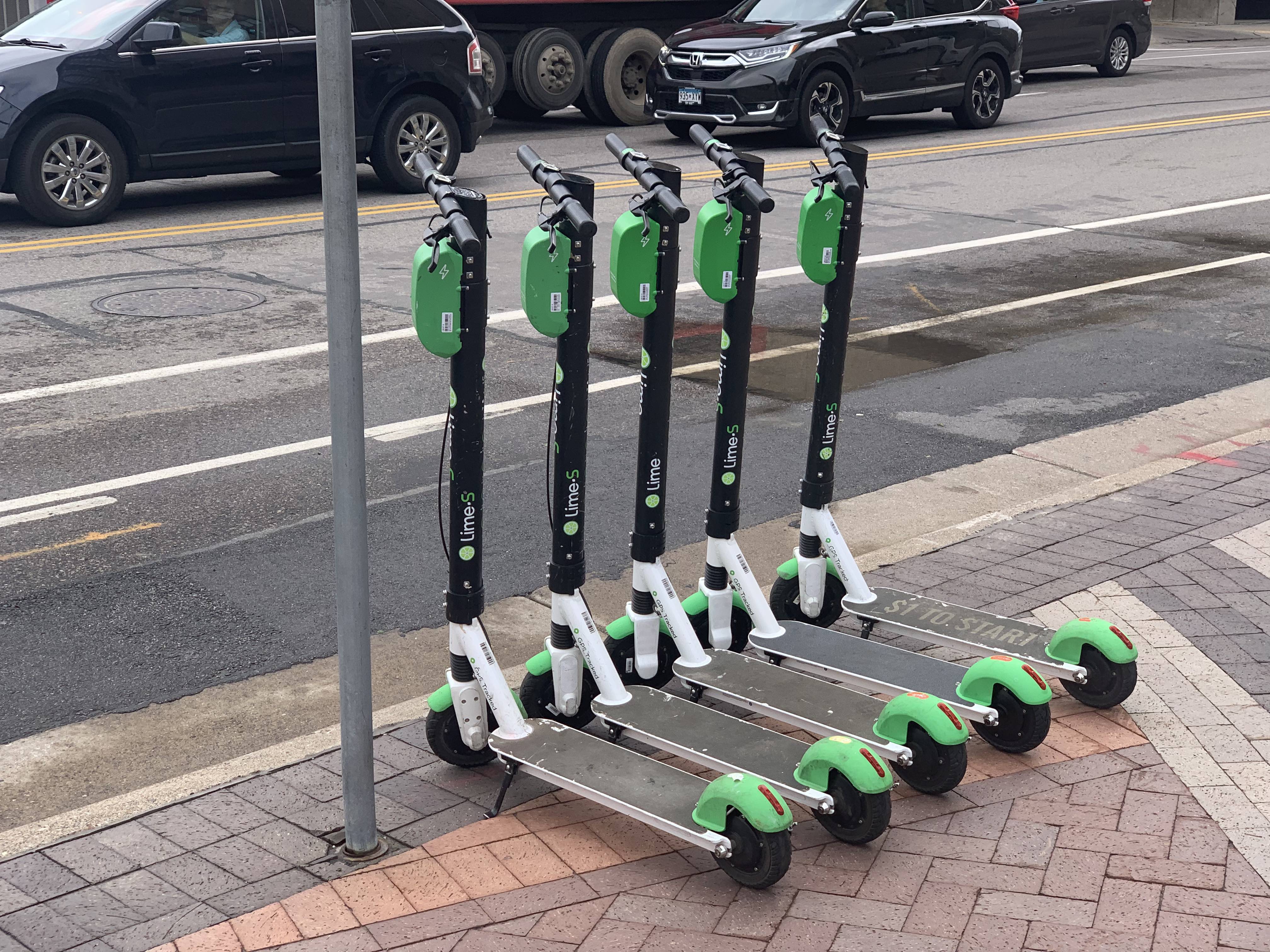 Lime scooters sit in a row at Gateway Park.