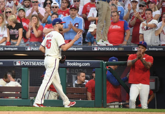 Oct 5, 2024; Philadelphia, PA, USA; Fans cheer as Philadelphia Phillies pitcher Zack Wheeler (45) heads to the dugout in the seventh inning against the New York Mets in game one of the NLDS for the 2024 MLB Playoffs at Citizens Bank Park. Mandatory Credit: Eric Hartline-Imagn Images