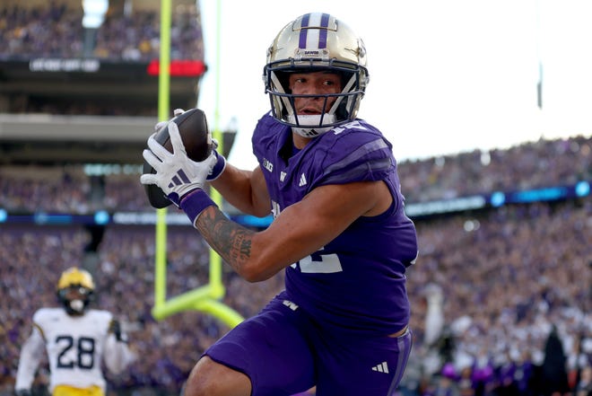 Denzel Boston of the Washington Huskies catches a touchdown pass during the first quarter against the Michigan Wolverines at Husky Stadium on October 5, 2024 in Seattle, Washington.