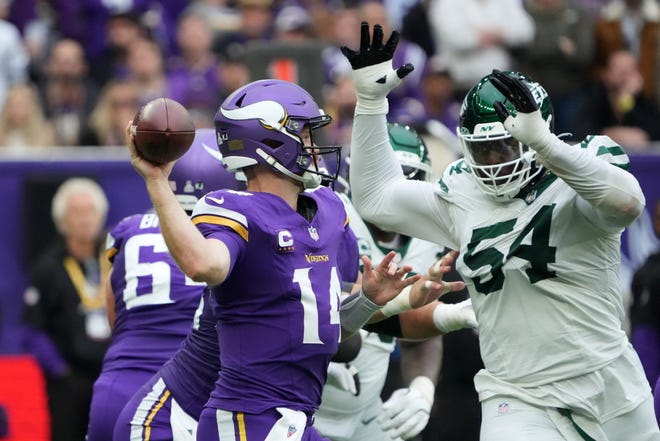 Oct 6, 2024; London, United Kingdom; Minnesota Vikings quarterback Sam Darnold (14) throws the ball against New York Jets defensive tackle Javon Kinlaw (54) in the first half at Tottenham Hotspur Stadium. Mandatory Credit: Kirby Lee-Imagn Images